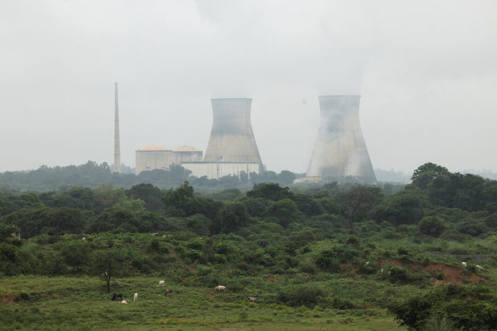 Cooling towers of a power plant surrounded by greenery