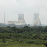 Cooling towers of a power plant surrounded by greenery